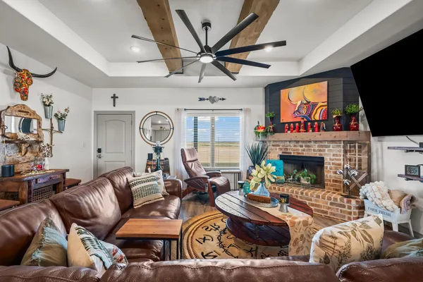 a living room with furniture a fireplace and a flat screen tv