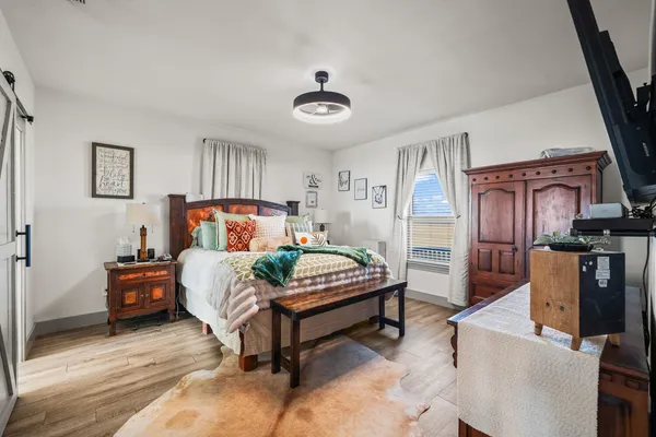 a bedroom with furniture and a window