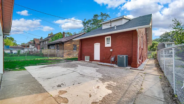 a backyard of a house with barbeque oven fire pit table and chairs