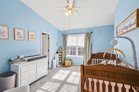 a bedroom with a bed a window and dresser