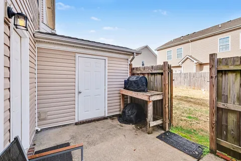 a view of a porch with furniture and floor to ceiling window