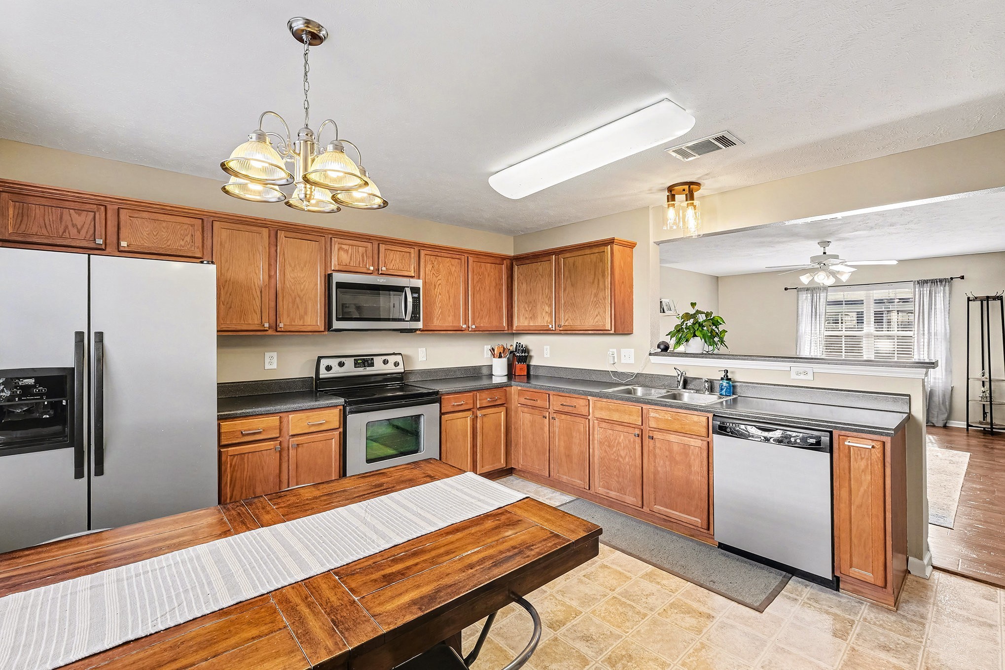 2039 George Buchanan La Vergne, TN 37086 - Photo 6 of 18 a kitchen with stainless steel appliances granite countertop a stove refrigerator dining table and chairs