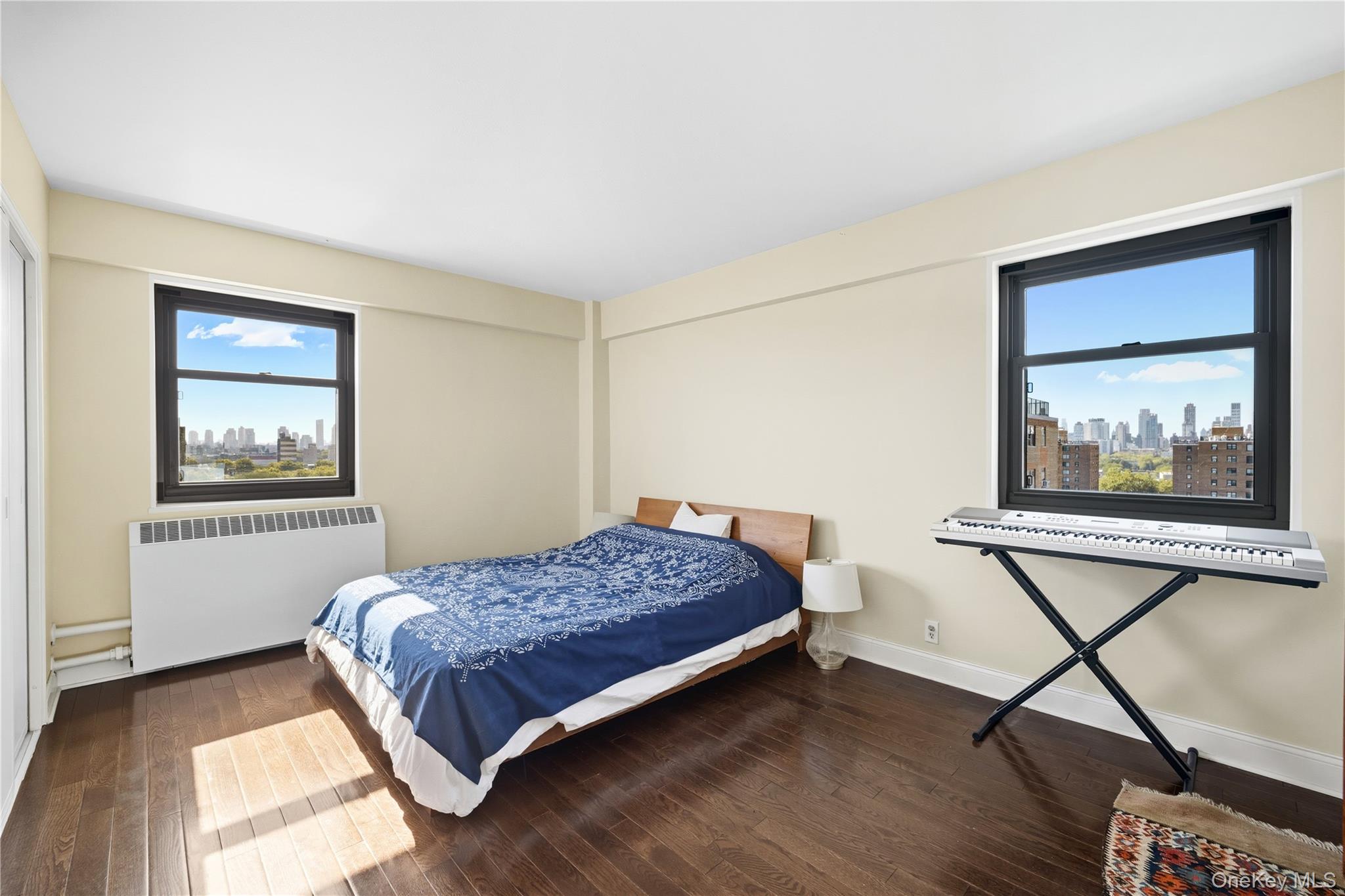 21-20 33rd Road, Unit 15C Queens, NY 11106 - Photo 11 of 18 a bedroom with a bed and a window