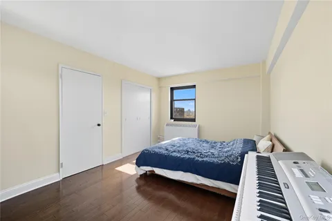 a spacious bedroom with a bed and a dresser