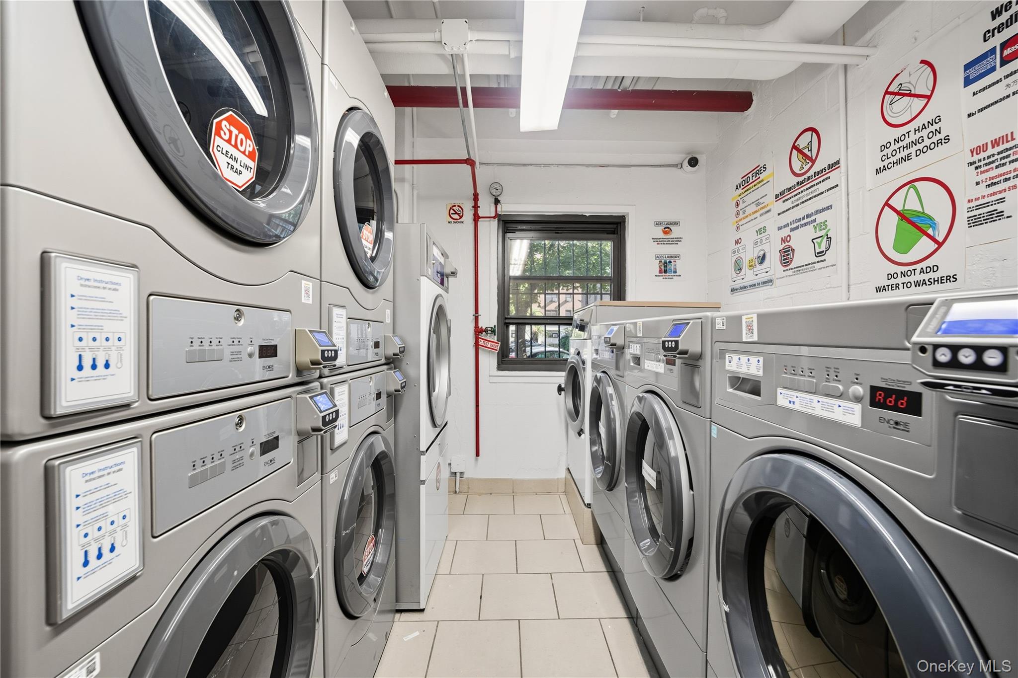 21-20 33rd Road, Unit 15C Queens, NY 11106 - Photo 14 of 18 a view of a storage & utility room with dryer and washer