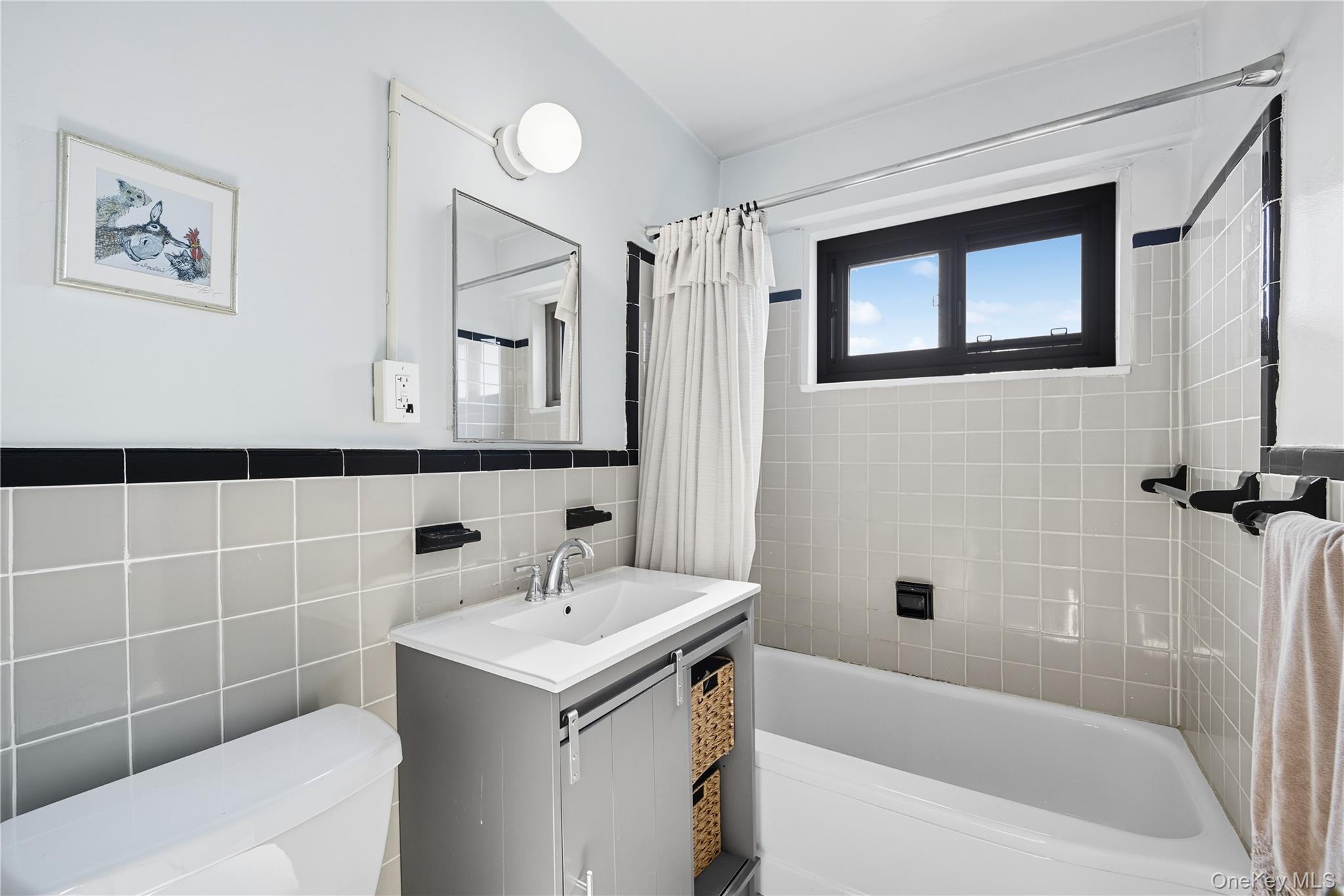 21-20 33rd Road, Unit 15C Queens, NY 11106 - Photo 8 of 18 a bathroom with a sink a toilet and shower