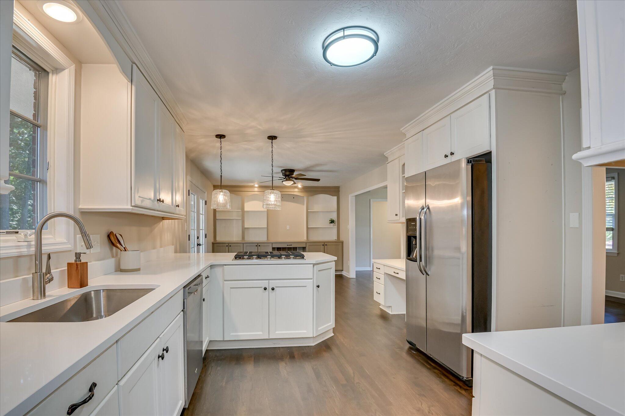 3122 Sussex Road Augusta, GA 30909 - Photo 8 of 33 Functional kitchen with newer stainless appliances, gas cooktop, bar seating, and built-in desk and shelving