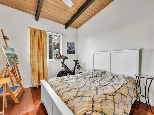 a bed sitting in a bedroom next to a window