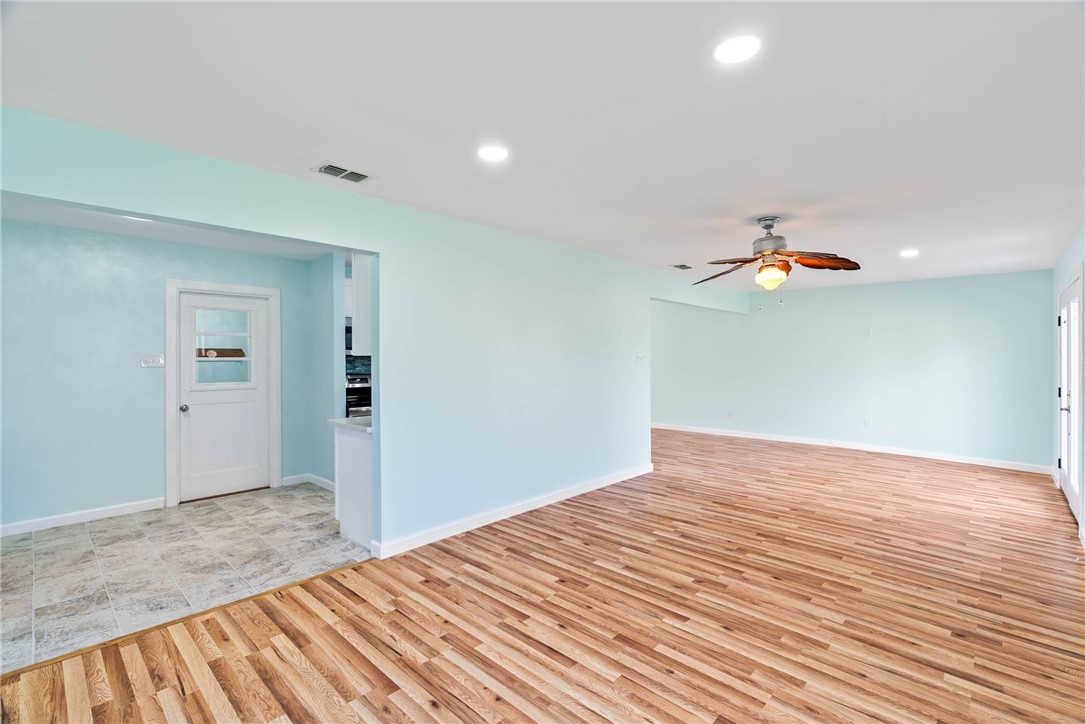 1703 Austin Street Portland, TX 78374 - Photo 4 of 13 a bedroom with a bed and a chandelier