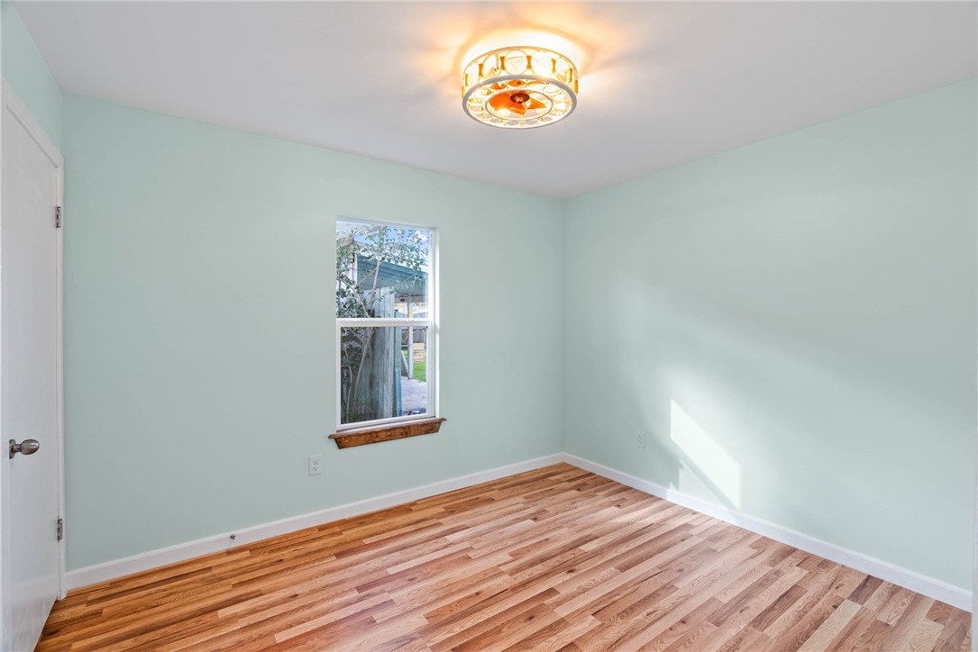 1703 Austin Street Portland, TX 78374 - Photo 6 of 13 a view of a hallway with wooden floor