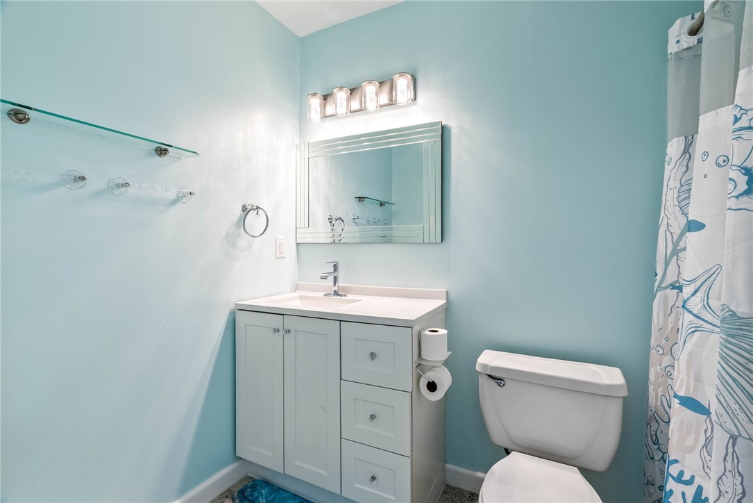 1703 Austin Street Portland, TX 78374 - Photo 7 of 13 a bathroom with a toilet sink and mirror