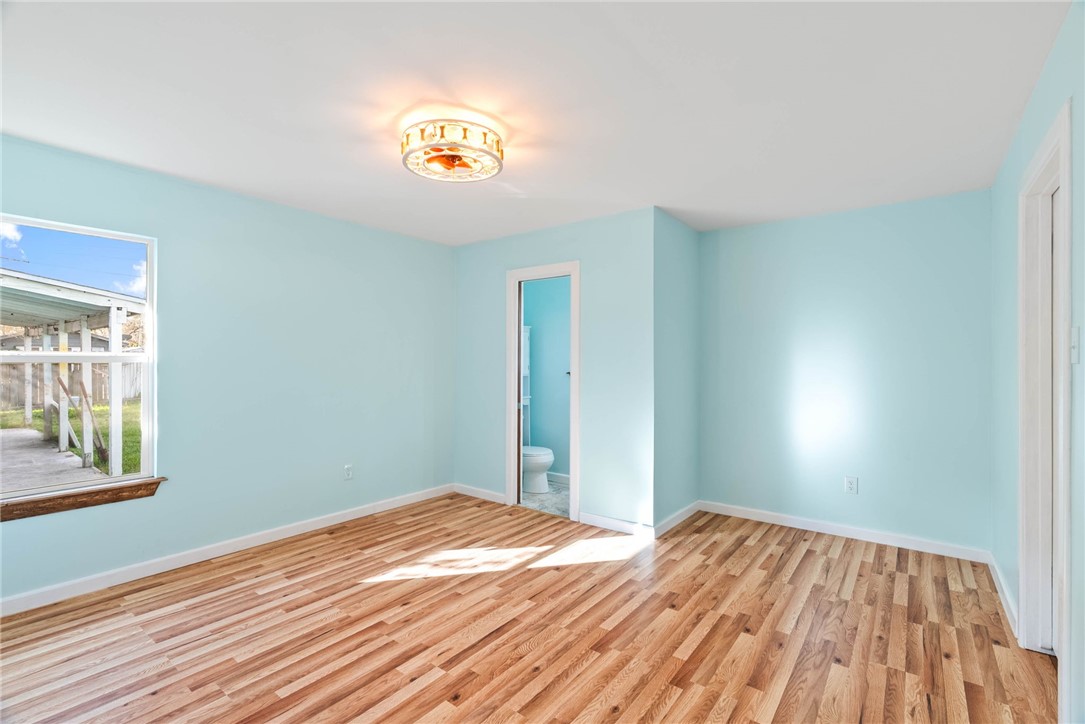 1703 Austin Street Portland, TX 78374 - Photo 8 of 13 a view of a room that has a bed and a window