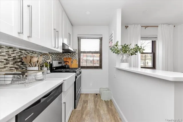 a kitchen with sink and cabinets