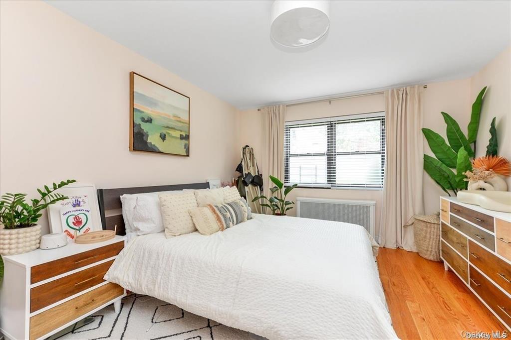 144-11 77th Road, Unit A Queens, NY 11367 - Photo 15 of 19 a bedroom with a bed and a window