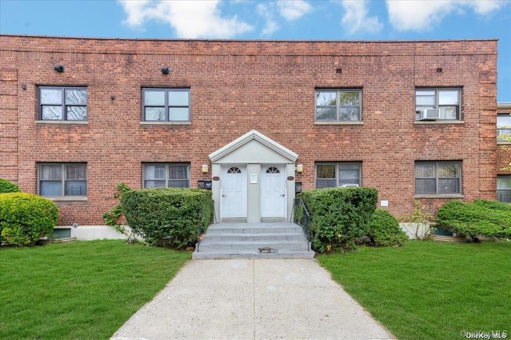 144-11 77th Road, Unit A Queens, NY 11367 - Photo 18 of 19 front view of a brick house with a yard