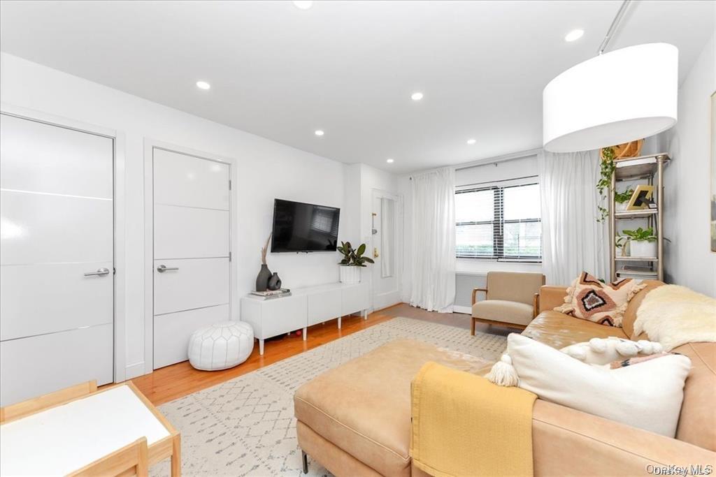 144-11 77th Road, Unit A Queens, NY 11367 - Photo 3 of 19 a bedroom with furniture and a flat screen tv