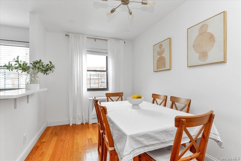 144-11 77th Road, Unit A Queens, NY 11367 - Photo 8 of 19 a bedroom with a bed and a chandelier