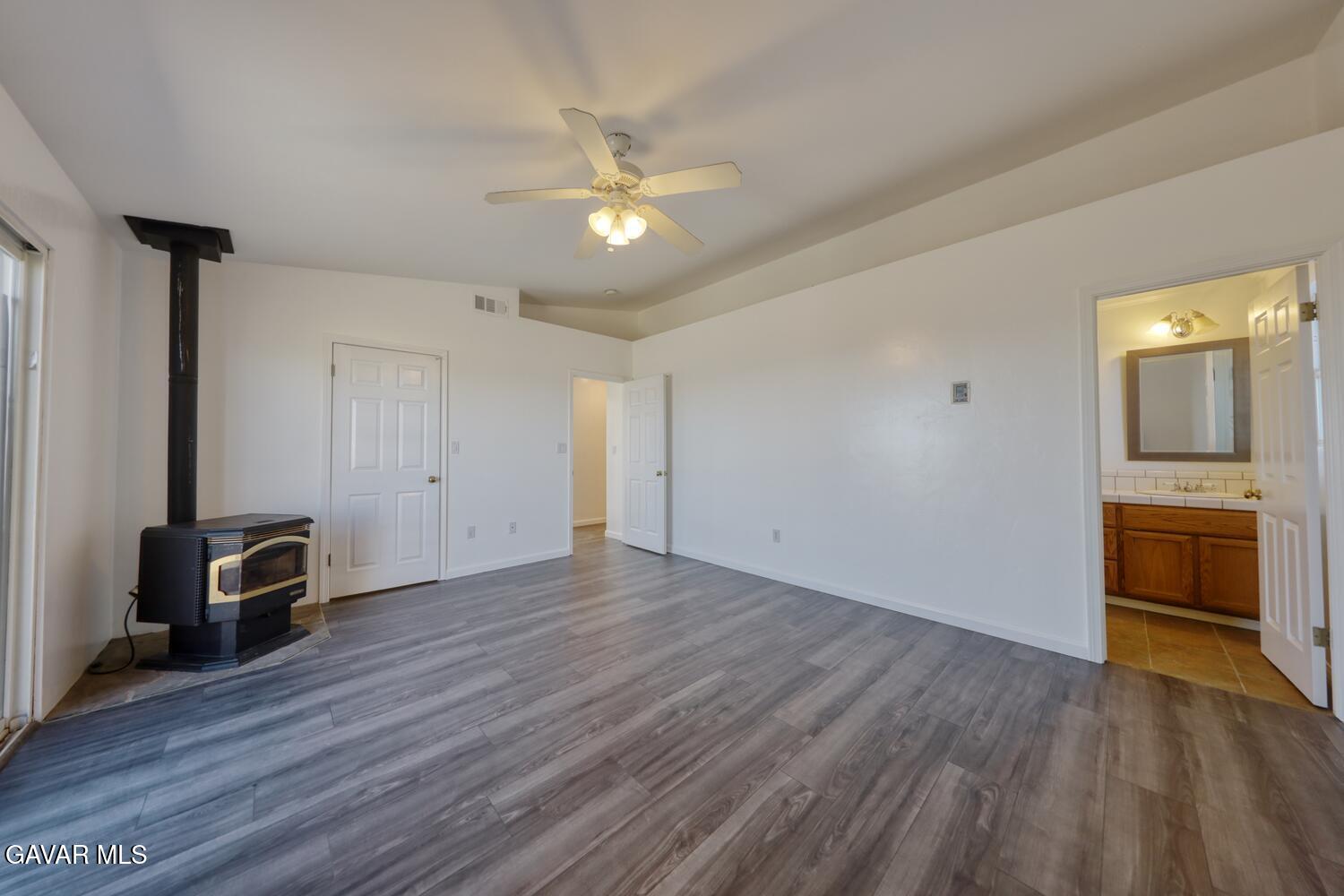 26801 Cabriolet Court Tehachapi, CA 93561 - Photo 22 of 60 an empty room with wooden floor and a ceiling fan