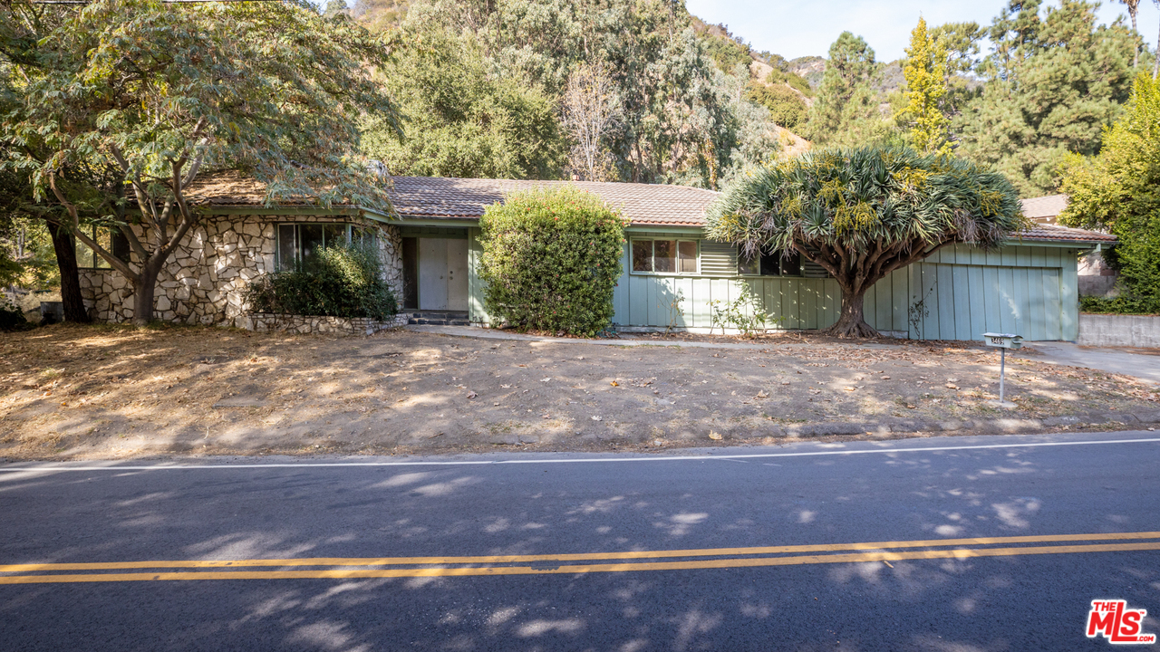 3469 Mandeville Canyon Road Los Angeles, CA 90049 - Photo 1 of 10 a front view of a house with a yard