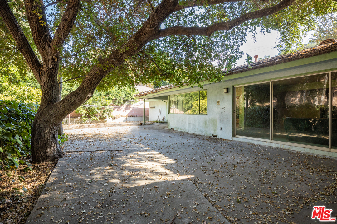 3469 Mandeville Canyon Road Los Angeles, CA 90049 - Photo 2 of 10 a view of a house with a tree in front of it
