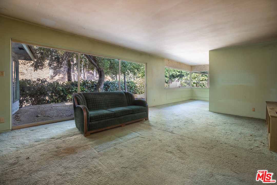 3469 Mandeville Canyon Road Los Angeles, CA 90049 - Photo 7 of 10 a living room with furniture and a large window