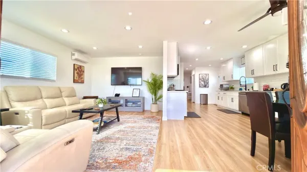 a living room with furniture and kitchen view