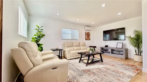 a living room with furniture and a flat screen tv