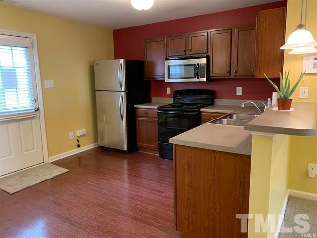 8914 Thornton Garden Lane Raleigh, NC 27616 - Photo 2 of 8 a kitchen with a refrigerator sink and stove