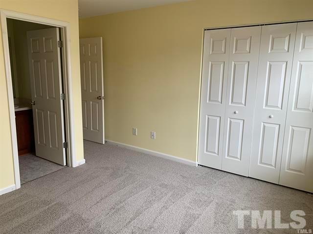 8914 Thornton Garden Lane Raleigh, NC 27616 - Photo 7 of 8 an empty room with a door