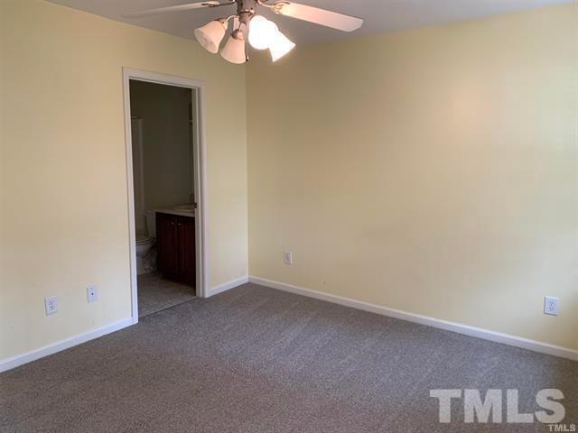8914 Thornton Garden Lane Raleigh, NC 27616 - Photo 8 of 8 an empty room with a chandelier fan