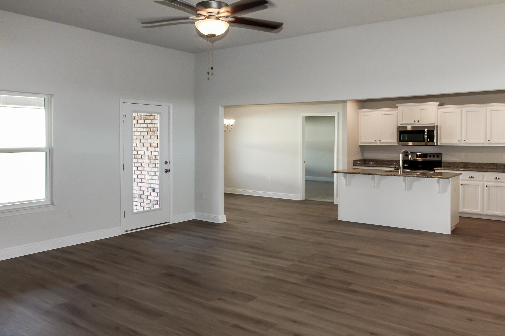 2613 Prominence Lane Crestview, FL 32536 - Photo 2 of 20 a view of a kitchen with a sink cabinets and wooden floor