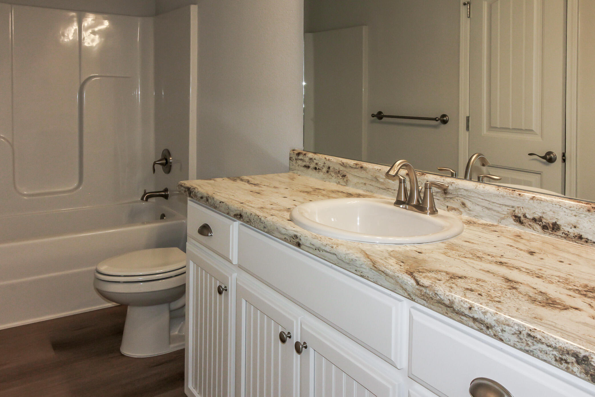 2613 Prominence Lane Crestview, FL 32536 - Photo 6 of 20 a bathroom with a granite countertop sink toilet and shower