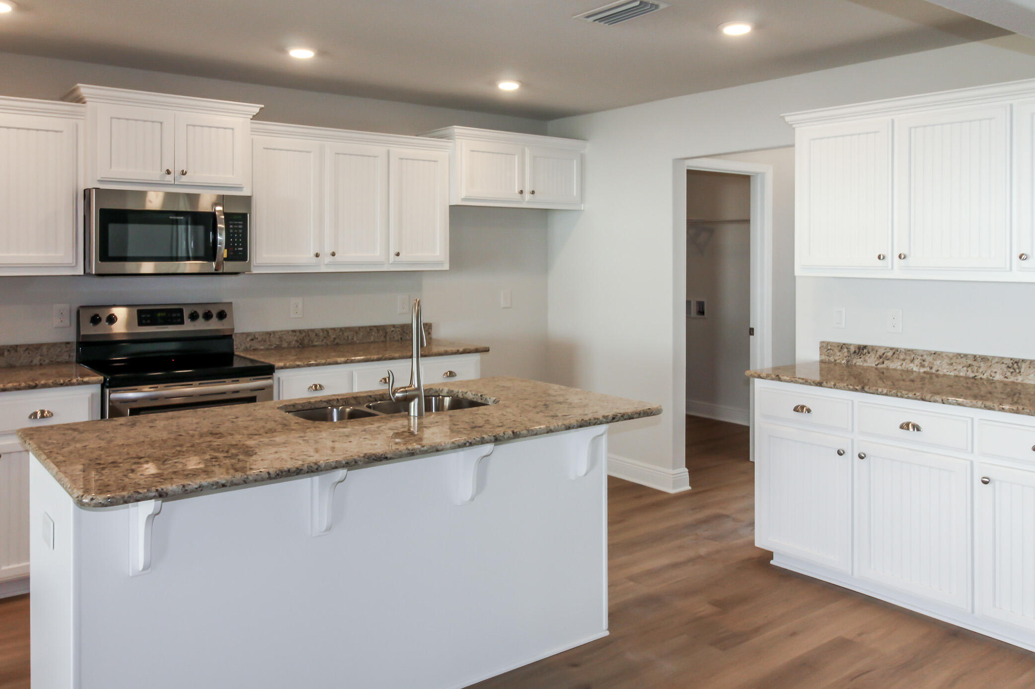 2613 Prominence Lane Crestview, FL 32536 - Photo 9 of 20 a kitchen with stainless steel appliances granite countertop a sink a stove a microwave and cabinets