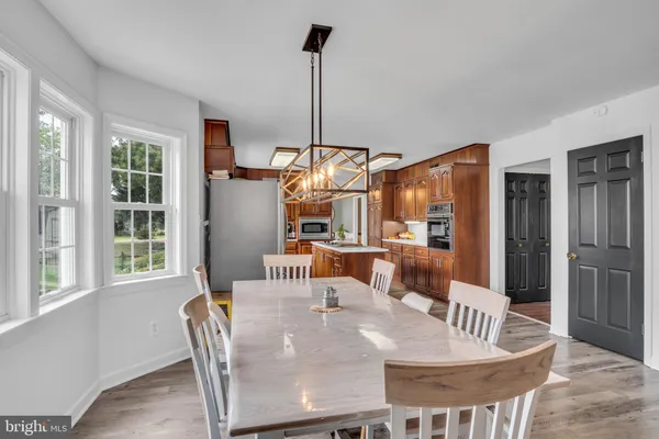 a living room with furniture a ceiling fan and a flat screen tv