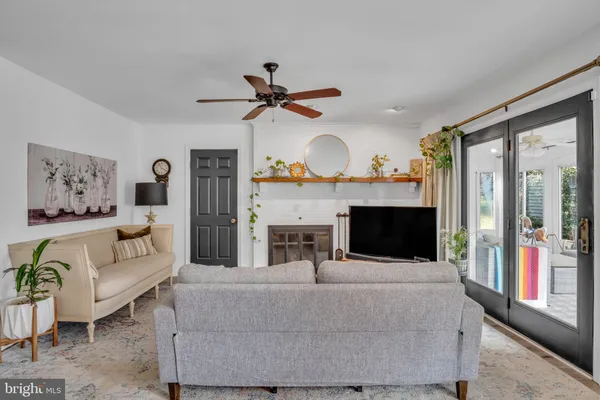 a living room with furniture and large windows