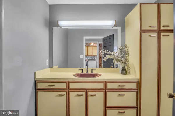 a spacious bedroom with bed and a chandelier