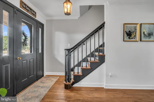 a view of entryway and hall with wooden floor