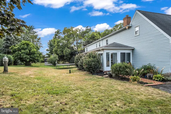 a picture of a room with a white bed and white cabinets