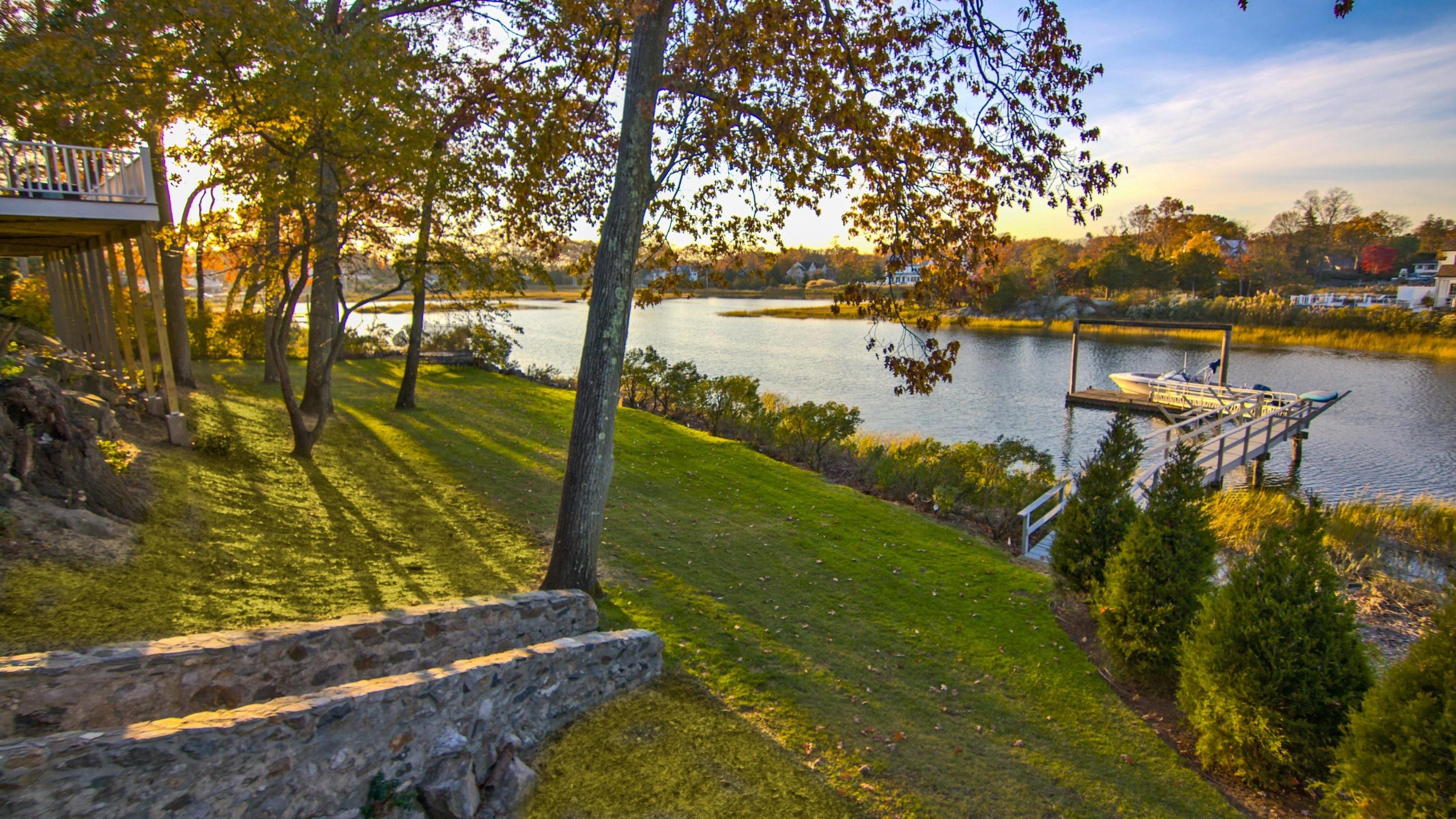 5 N Road Darien, CT 06820 - Photo 8 of 38 a view of a lake with houses next to a yard