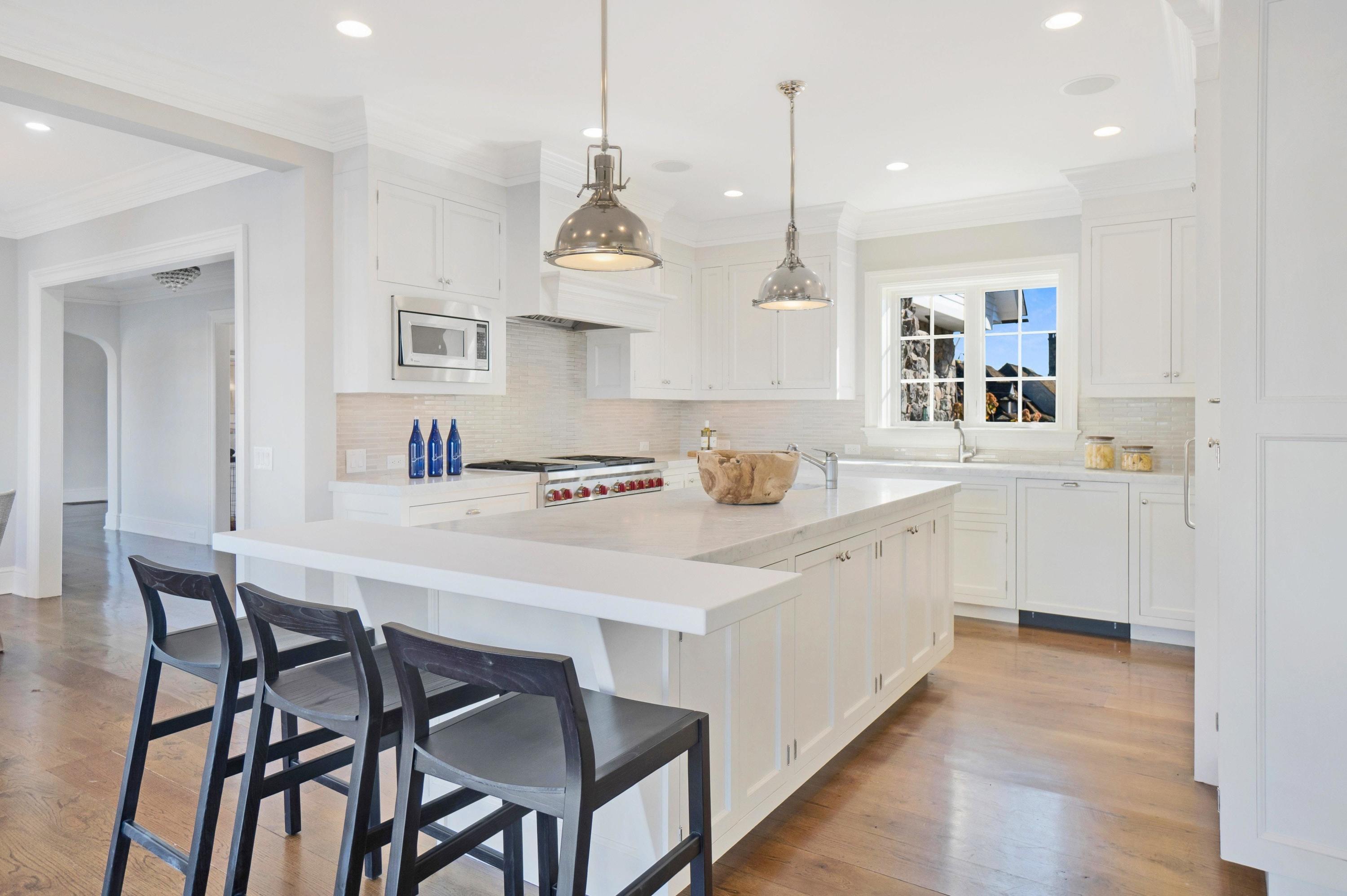 5 N Road Darien, CT 06820 - Photo 9 of 38 a kitchen with a dining table chairs sink and cabinets