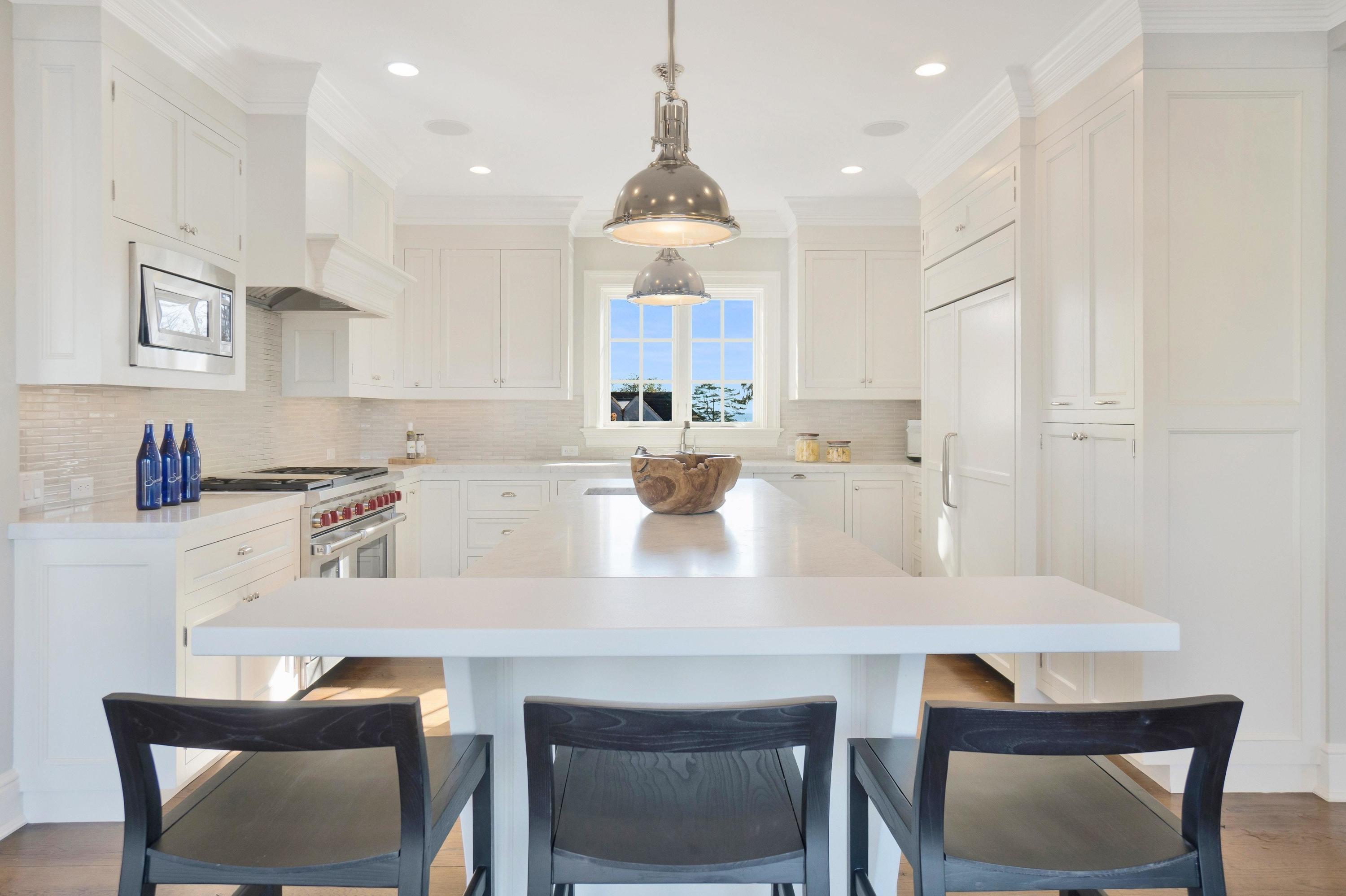 5 N Road Darien, CT 06820 - Photo 10 of 38 a kitchen with kitchen island a stove a table and chairs in it