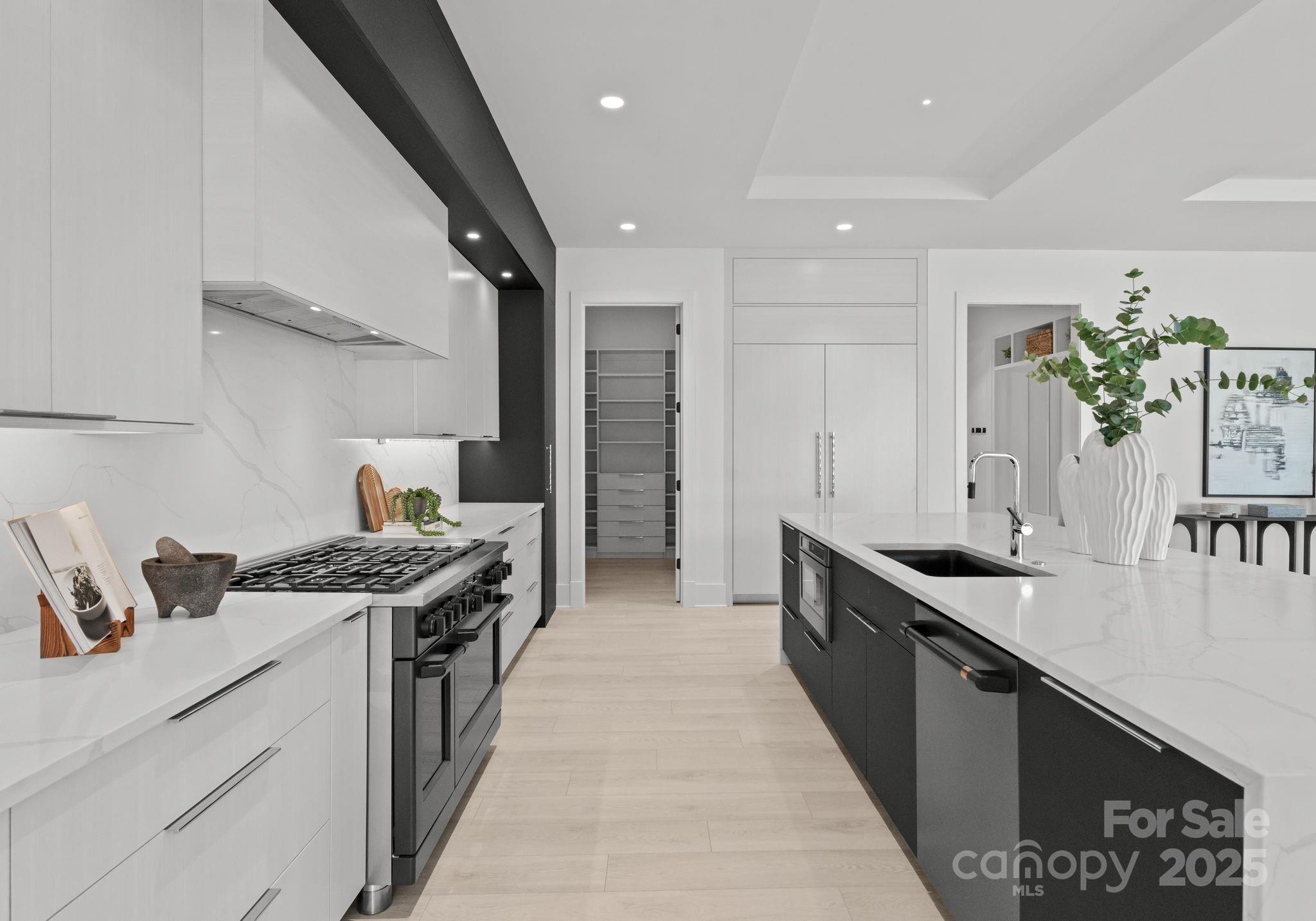 5428 Carmel Road Charlotte, NC 28226 - Photo 17 of 29 a kitchen with stainless steel appliances granite countertop a sink stove and cabinets