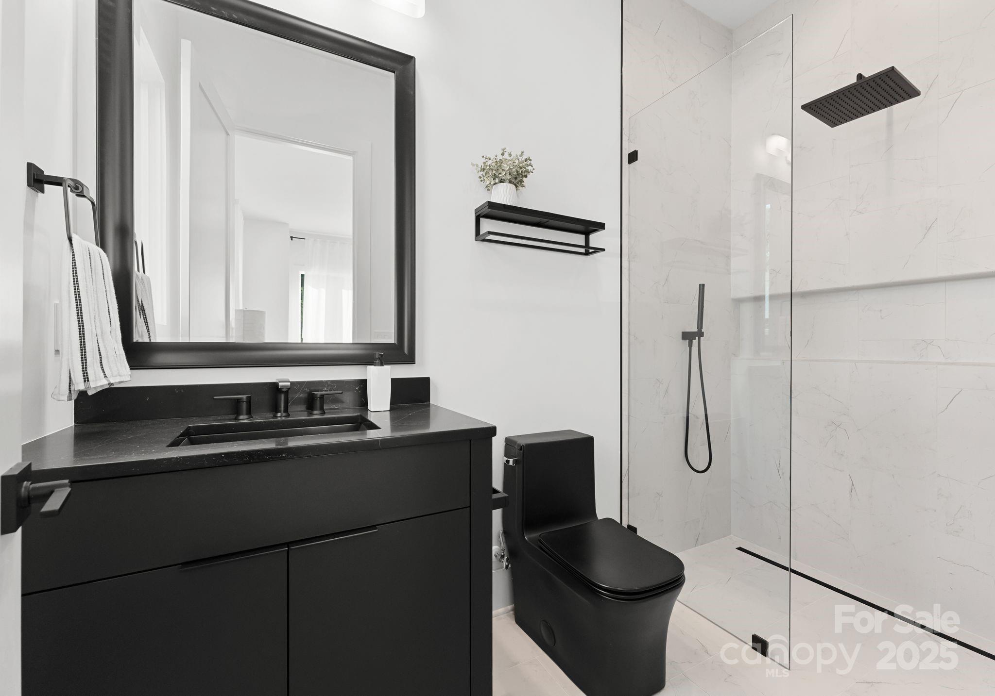 5428 Carmel Road Charlotte, NC 28226 - Photo 27 of 29 a bathroom with a sink a toilet and a mirror