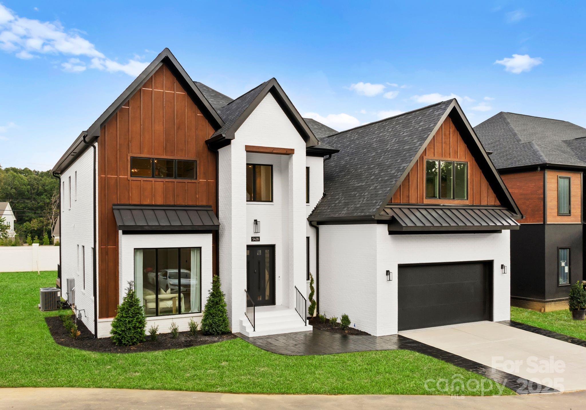 5428 Carmel Road Charlotte, NC 28226 - Photo 3 of 29 a front view of a house with a yard