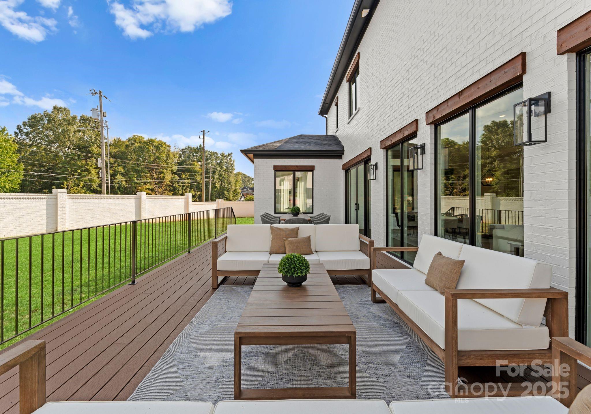 5428 Carmel Road Charlotte, NC 28226 - Photo 6 of 29 a view of a patio with couches table and chairs and potted plants