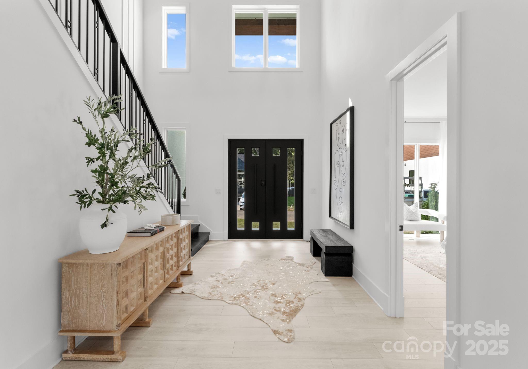 5428 Carmel Road Charlotte, NC 28226 - Photo 8 of 29 a view of a hallway with wooden floor and stairs
