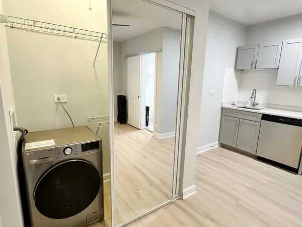 a view of a kitchen with sink and cabinets