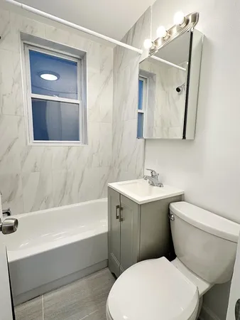 a bathroom with a toilet a sink and bathtub