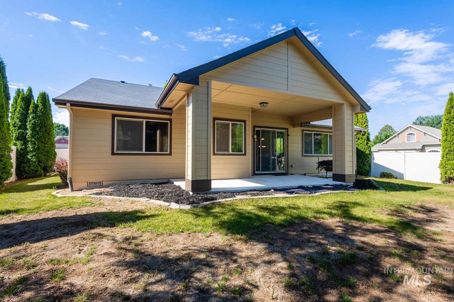 1186 East Observation Street Meridian, ID 83642 - Photo 33 of 33 Rear exterior featuring a covered patio, tan siding, and a dark shingle roof