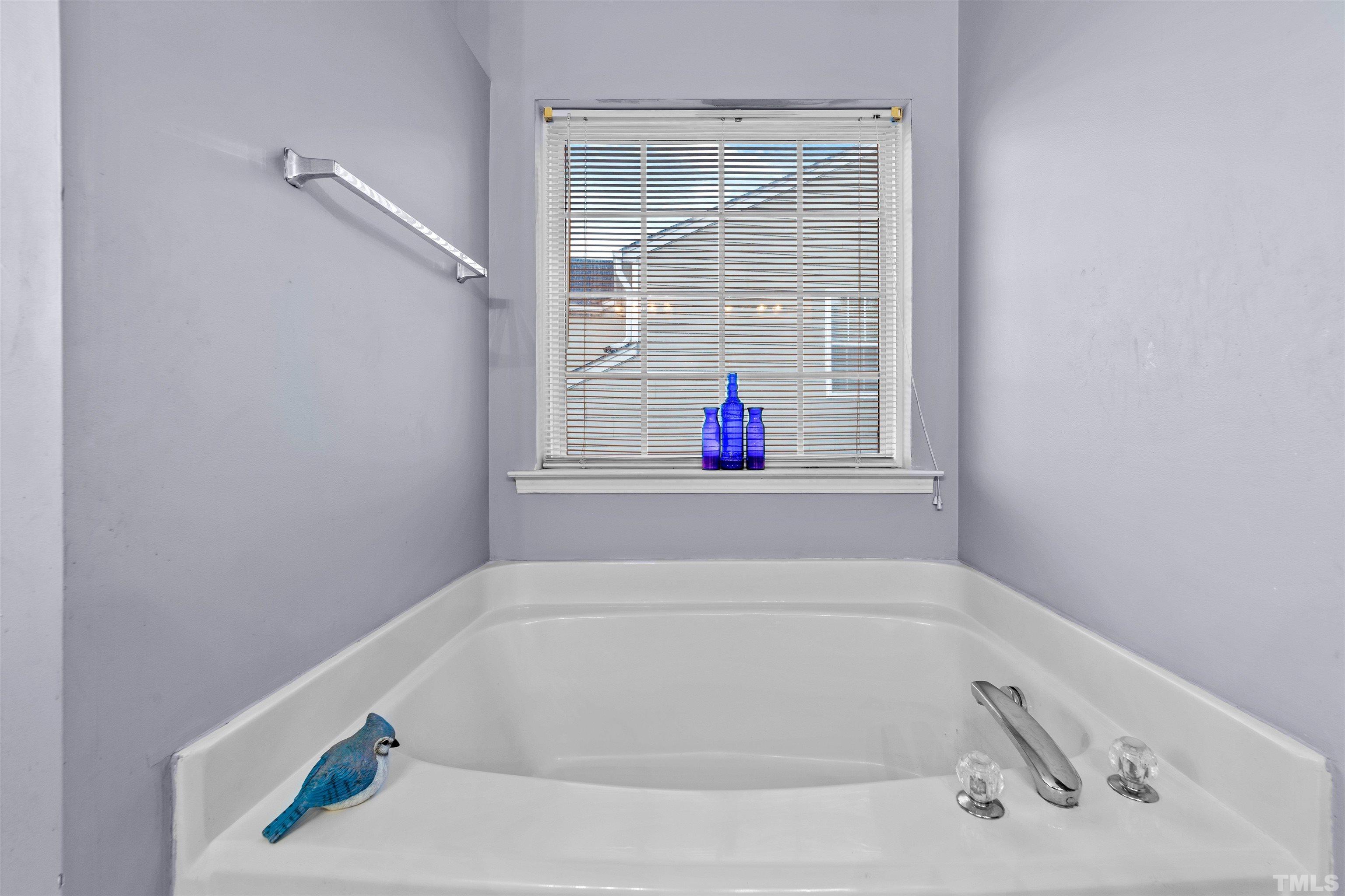 3309 Marshlane Way Raleigh, NC 27610 - Photo 14 of 24 a white bath tub sitting next to a window
